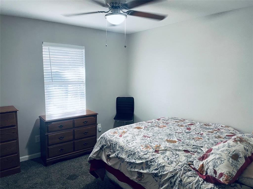 Room featuring neutral-toned walls, carpeting, and a ceiling fan with integrated lighting Room featuring neutral-toned walls, carpeting, and a ceiling fan with integrated lighting