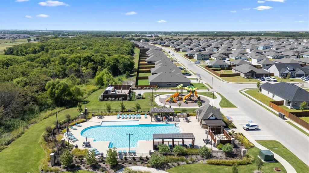 Community amenities featuring an outdoor swimming pool, shaded pavilion structures, and a playground area surrounded by landscaped grounds