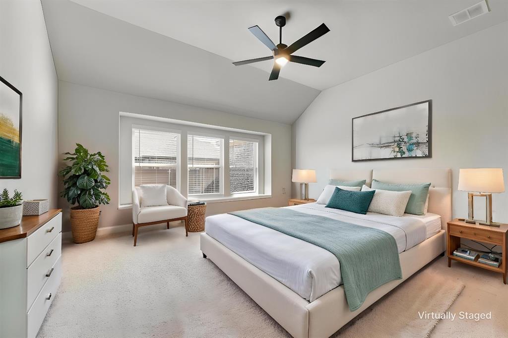 Vaulted ceilings featuring a black multi-blade ceiling fan and a triple-pane window alcove