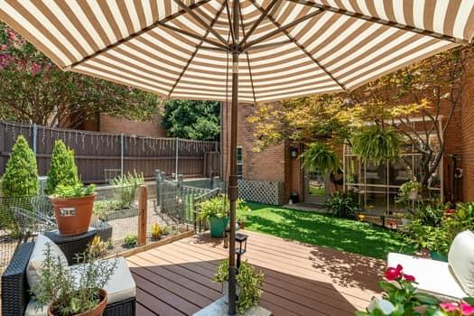 Composite deck featuring a brick exterior wall, screened-in enclosure, and perimeter privacy fencing Composite deck featuring a brick exterior wall, screened-in enclosure, and perimeter privacy fencing