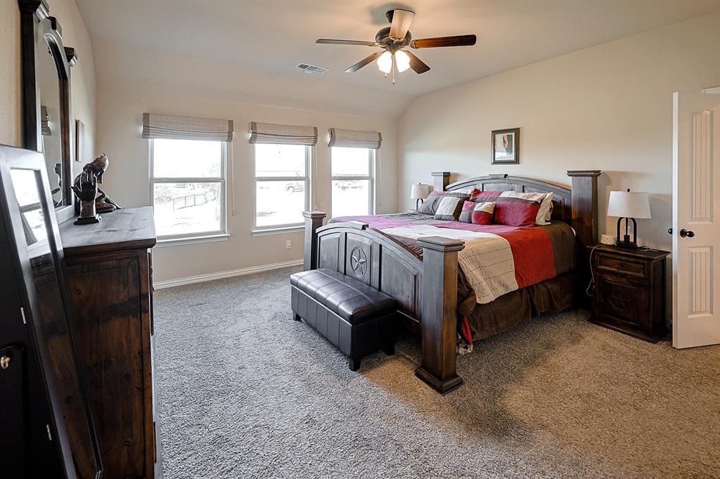 Vaulted ceiling, three picture windows, and a ceiling fan with integrated lighting