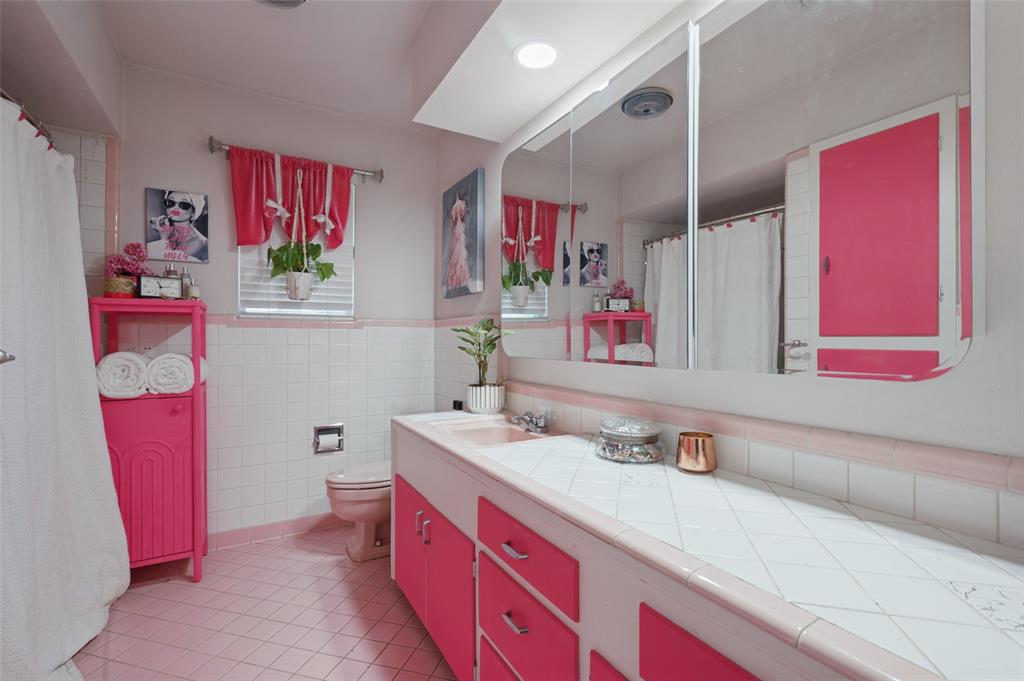 The full bathroom is accessible from the hallway and has a shower/tub combo, lots of cabinets, and a long counter.