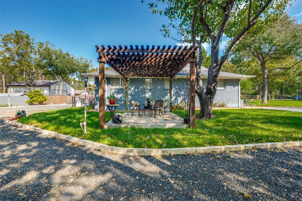 As you approach the house, don't miss this adorable courtyard with pergola.