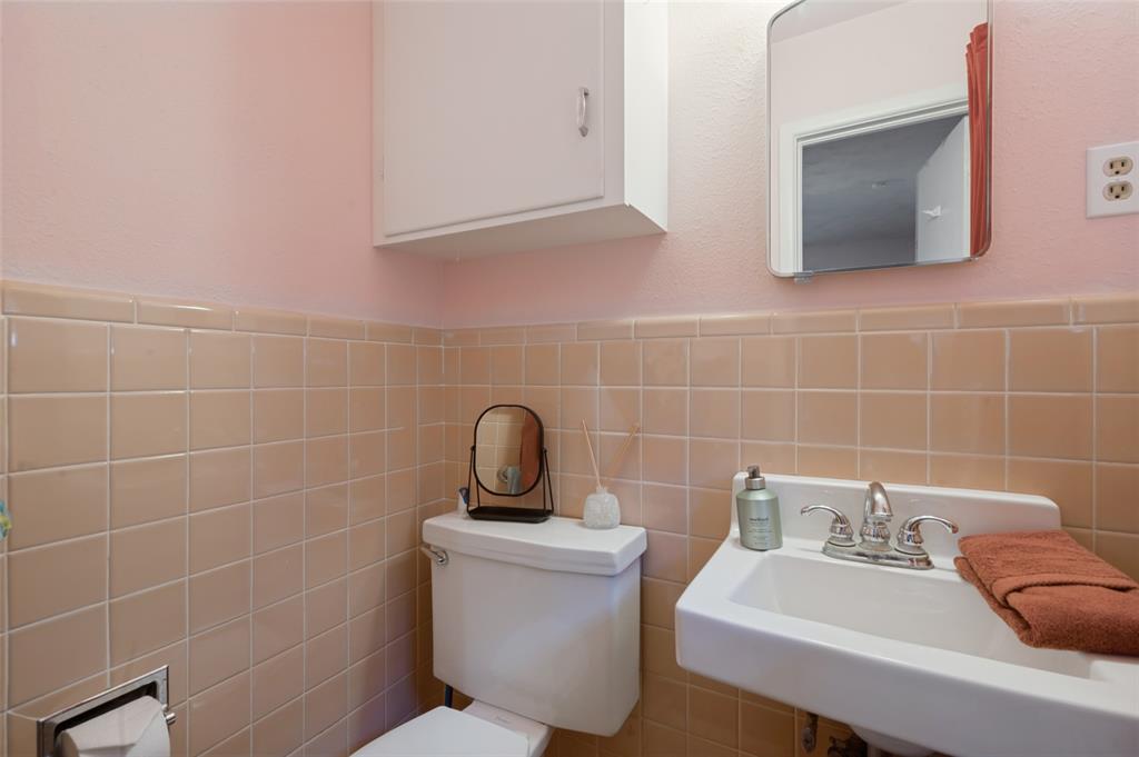 This half bathroom is connected to the rear bedroom.