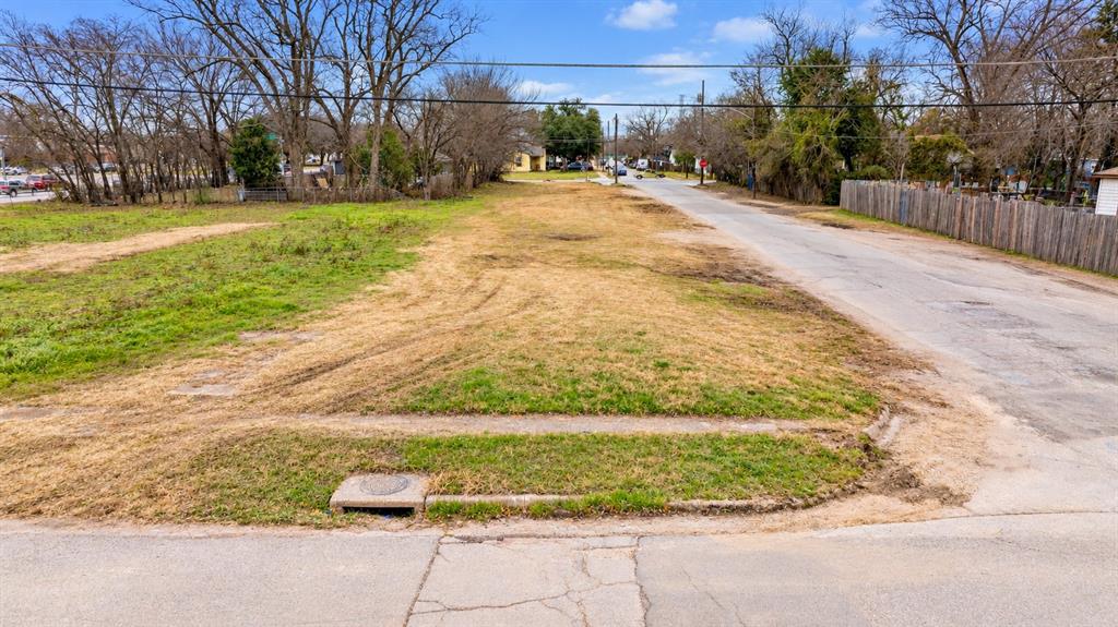 Vacant corner lot featuring street-level utility access and mature perimeter trees Vacant corner lot featuring street-level utility access and mature perimeter trees