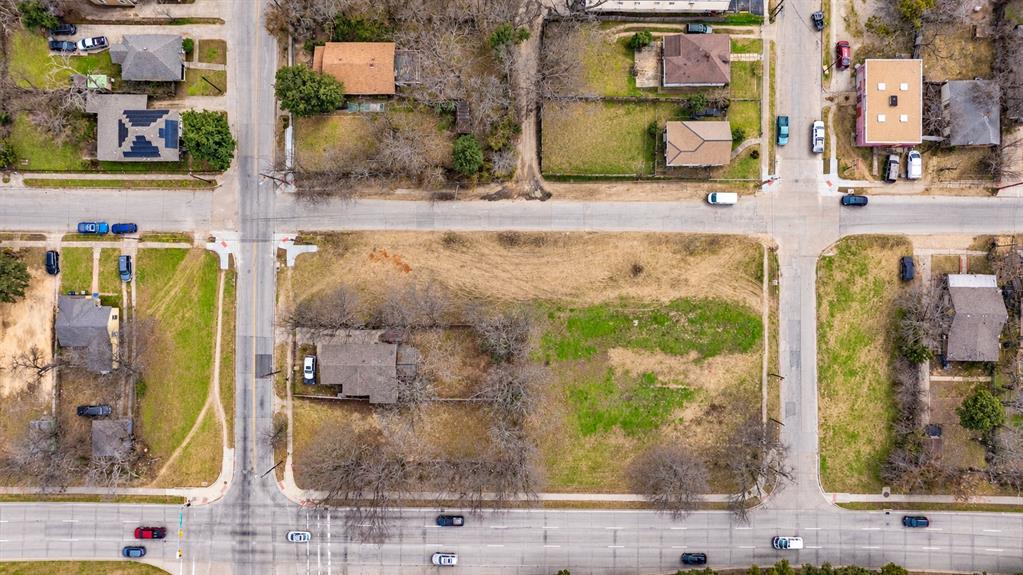 Expansive corner lot situated at the intersection of two paved streets, featuring established mature trees and open green space Expansive corner lot situated at the intersection of two paved streets, featuring established mature trees and open green space
