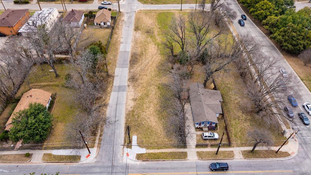 Corner lot with expansive open grounds, mature trees, and existing paved access Corner lot with expansive open grounds, mature trees, and existing paved access