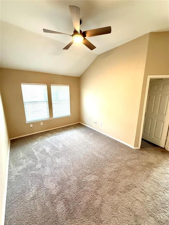 Vaulted ceilings with a central ceiling fan and light fixture, neutral wall finishes, carpeting, and dual-pane windows Vaulted ceilings with a central ceiling fan and light fixture, neutral wall finishes, carpeting, and dual-pane windows