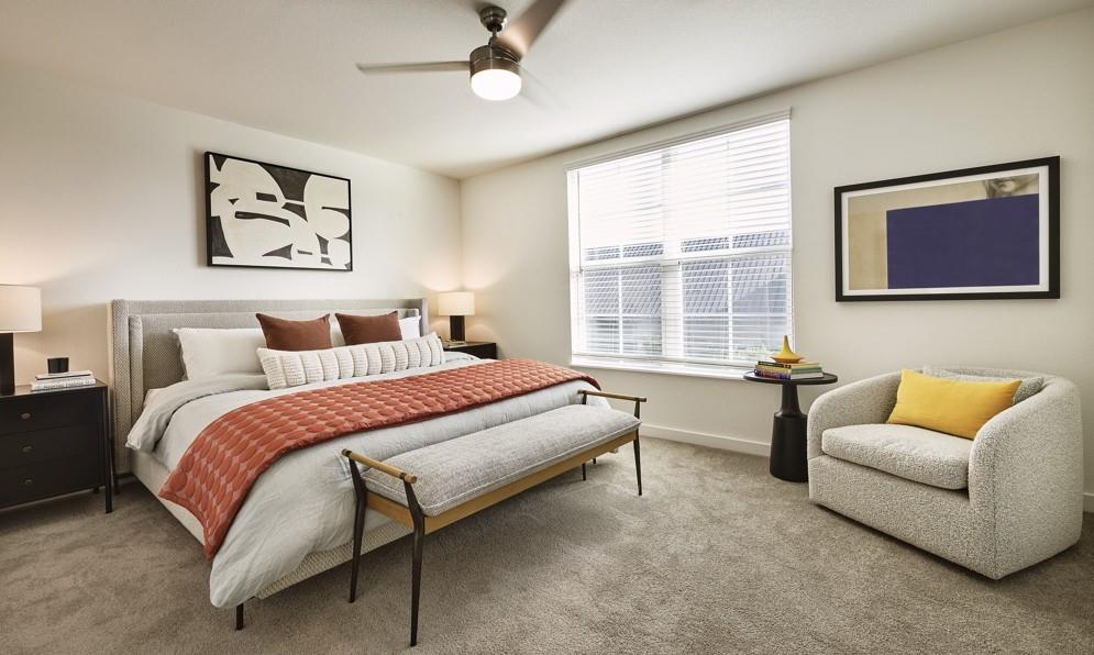Carpeted bedroom featuring baseboards and ceiling fan Carpeted bedroom featuring baseboards and ceiling fan