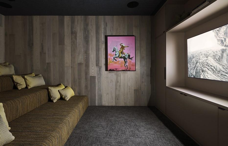 Home theater with carpet floors and wooden walls
