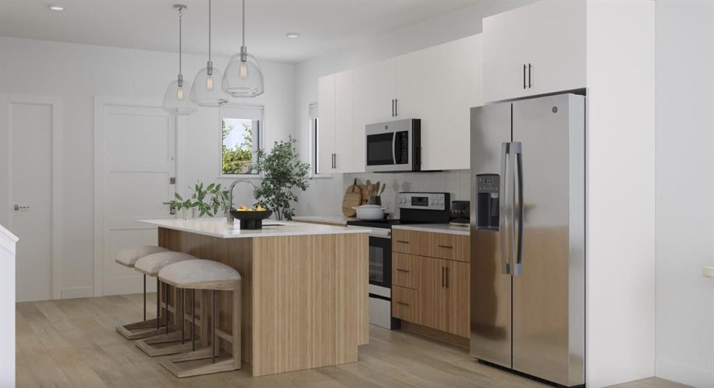 Kitchen with appliances with stainless steel finishes, a breakfast bar area, pendant lighting, tasteful backsplash, and white cabinets Kitchen with appliances with stainless steel finishes, a breakfast bar area, pendant lighting, tasteful backsplash, and white cabinets