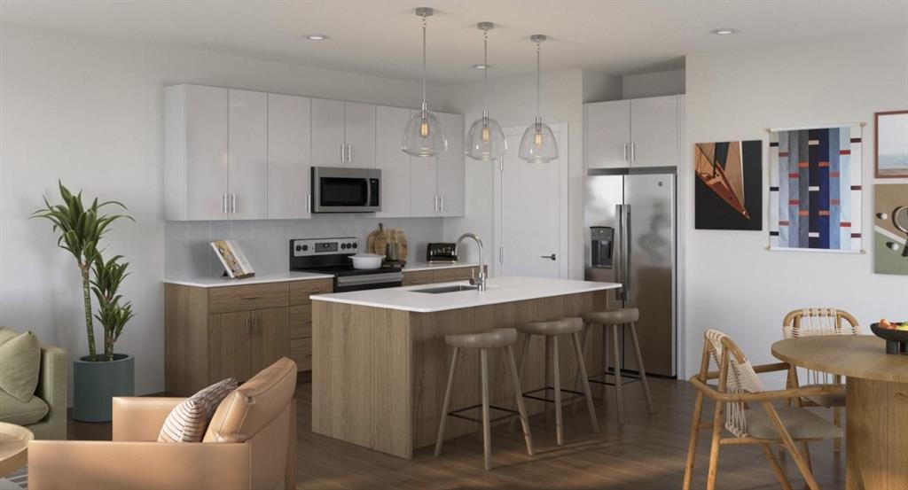 Kitchen featuring stainless steel appliances, a kitchen breakfast bar, hanging light fixtures, dark wood-style flooring, and recessed lighting Kitchen featuring stainless steel appliances, a kitchen breakfast bar, hanging light fixtures, dark wood-style flooring, and recessed lighting