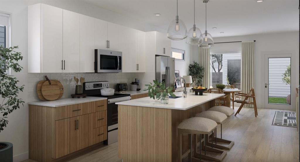 Kitchen featuring stainless steel appliances, an island with sink, a kitchen breakfast bar, tasteful backsplash, and hanging light fixtures Kitchen featuring stainless steel appliances, an island with sink, a kitchen breakfast bar, tasteful backsplash, and hanging light fixtures