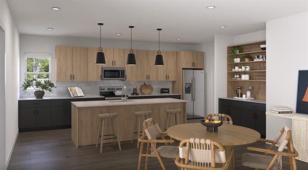 Kitchen with a kitchen island with sink, stainless steel appliances, pendant lighting, modern cabinets, and recessed lighting Kitchen with a kitchen island with sink, stainless steel appliances, pendant lighting, modern cabinets, and recessed lighting