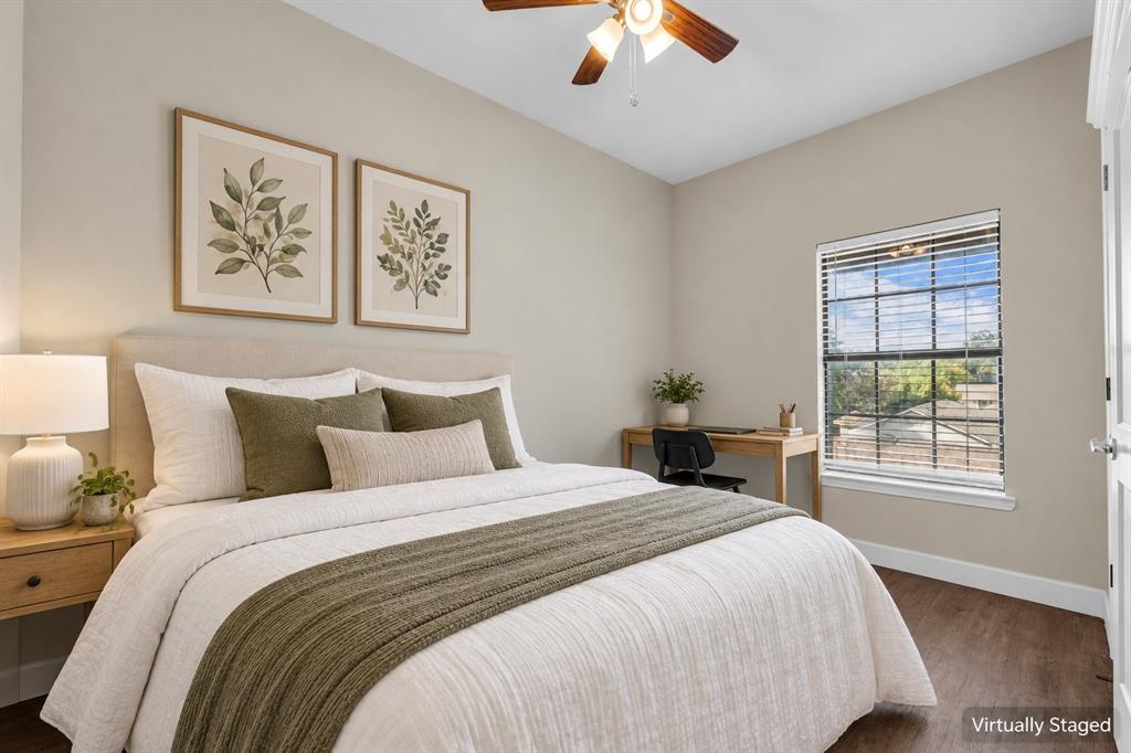Bedroom featuring wood-finish flooring, a neutral color palette, a single-hung window with horizontal blinds, and a ceiling fan with integrated lighting