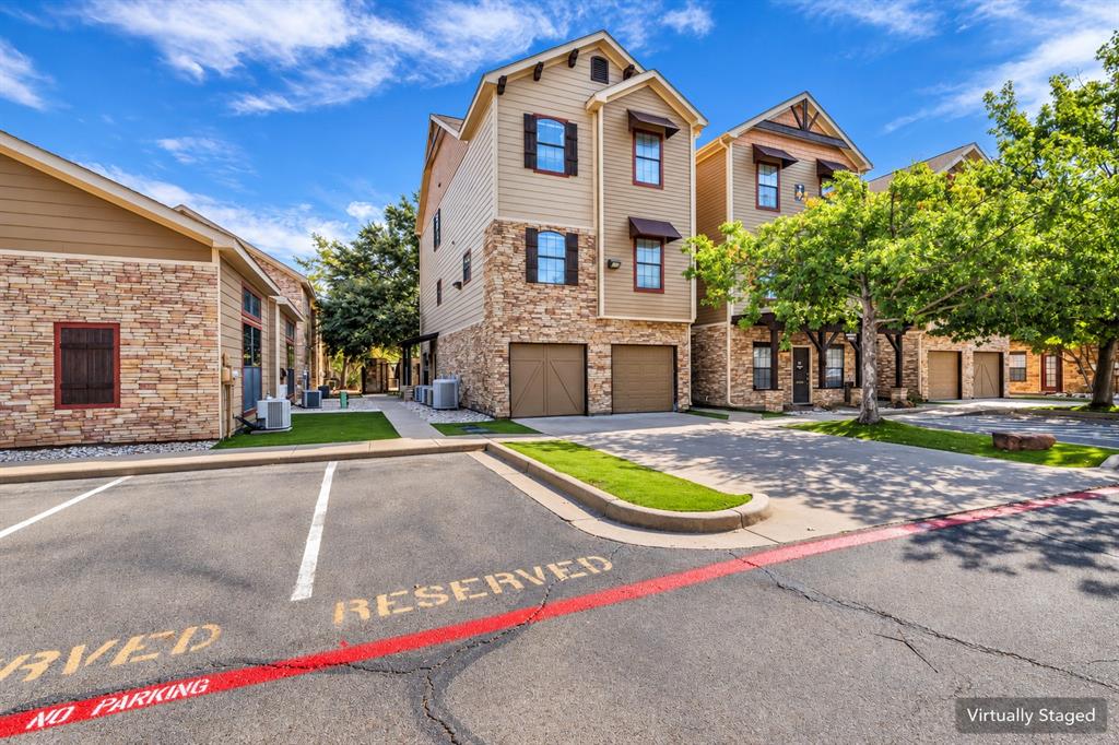Multi-story exterior featuring stone veneer siding, horizontal lap siding, and attached two-car garages Multi-story exterior featuring stone veneer siding, horizontal lap siding, and attached two-car garages