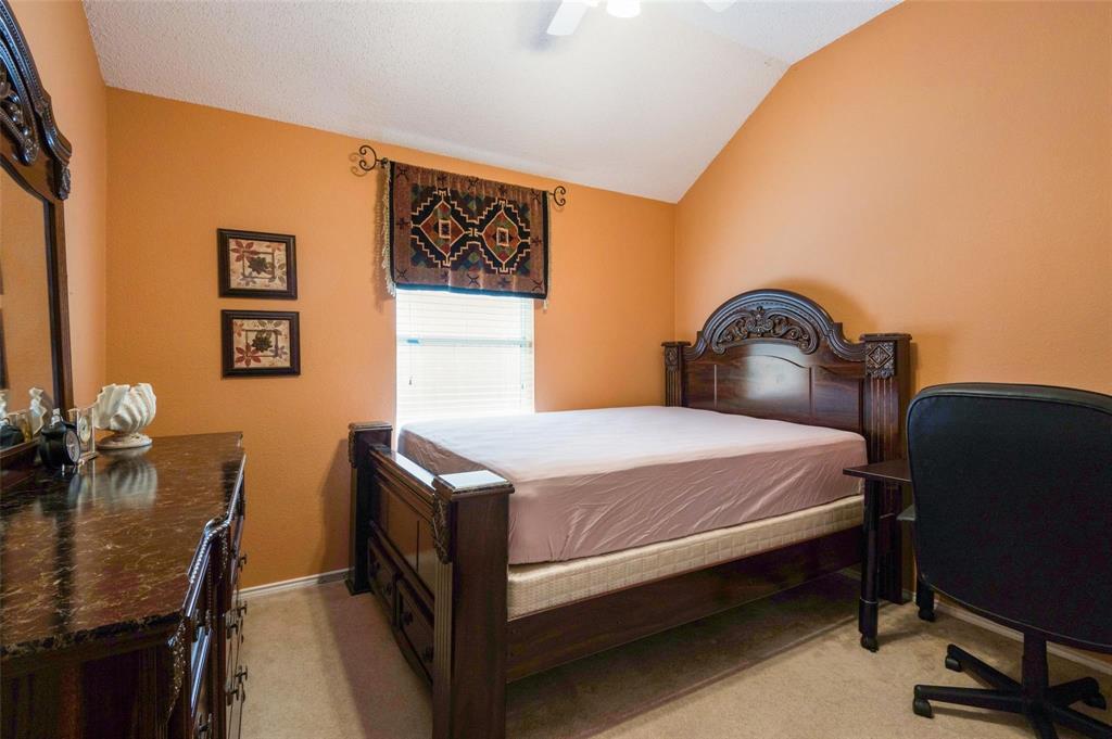 Vaulted ceiling with an attached white ceiling fan and neutral-toned carpeting