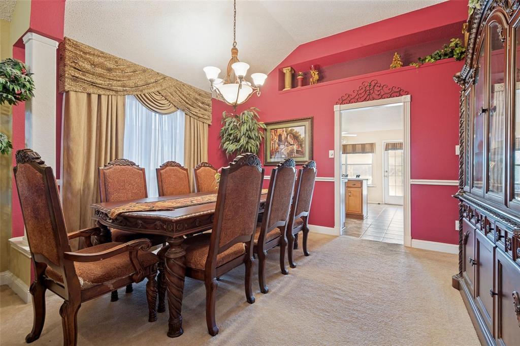 Vaulted ceiling featuring a central chandelier, decorative wall niche, and chair rail molding Vaulted ceiling featuring a central chandelier, decorative wall niche, and chair rail molding
