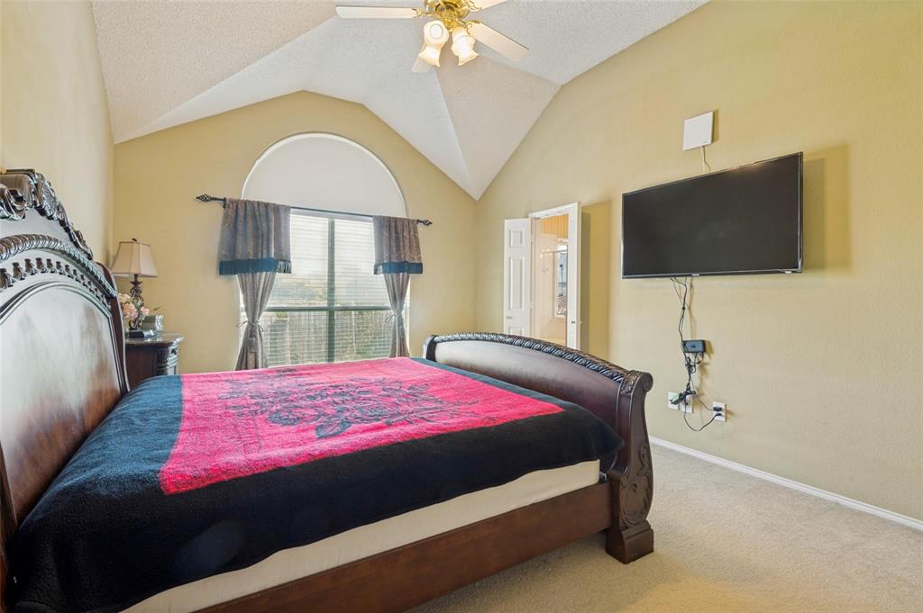 Vaulted ceiling, arched window, and overhead ceiling fan