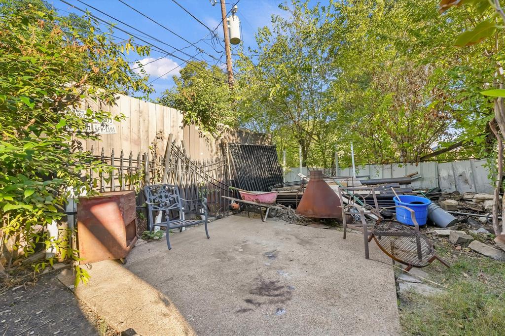 Concrete patio featuring a combination wood and metal perimeter fence