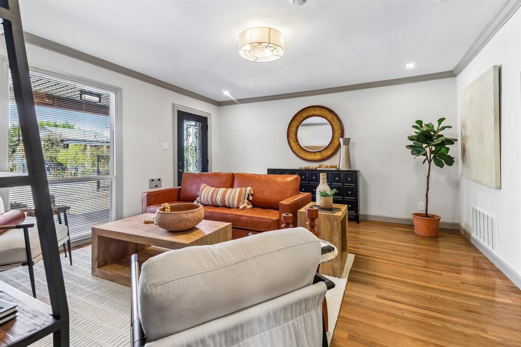Hardwood flooring throughout, recessed lighting, crown molding, and a decorative front entry door with glass inserts