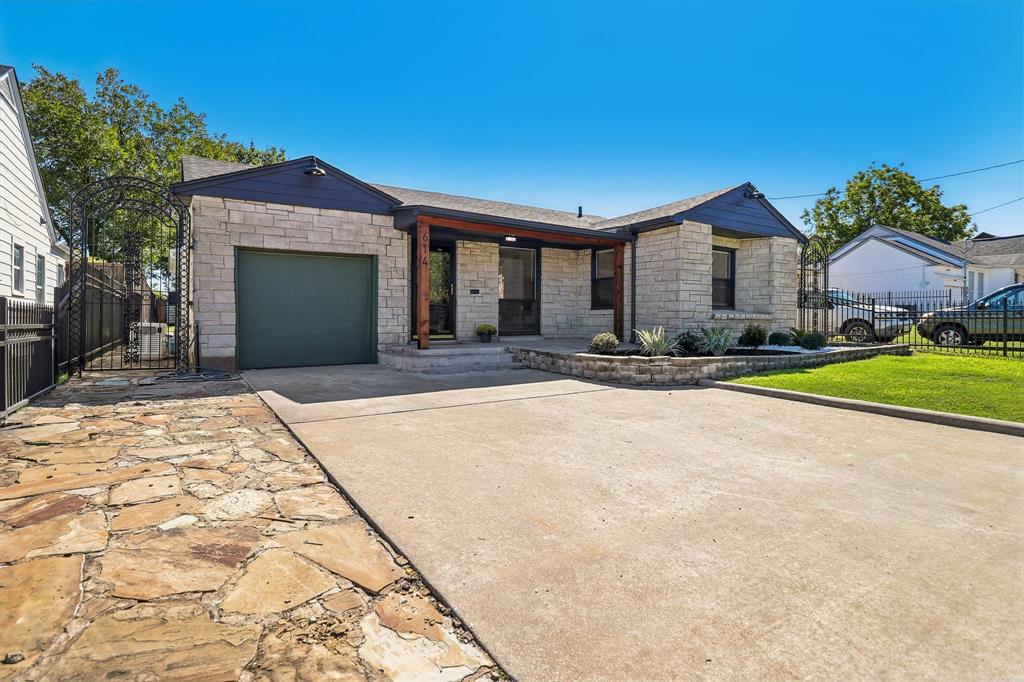 Stone facade exterior with a covered entry, concrete driveway, and a flagstone pathway Stone facade exterior with a covered entry, concrete driveway, and a flagstone pathway