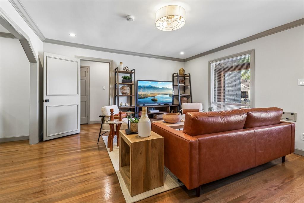 Hardwood flooring, recessed lighting, crown molding, paneled interior doors, and a decorative ceiling light fixture Hardwood flooring, recessed lighting, crown molding, paneled interior doors, and a decorative ceiling light fixture