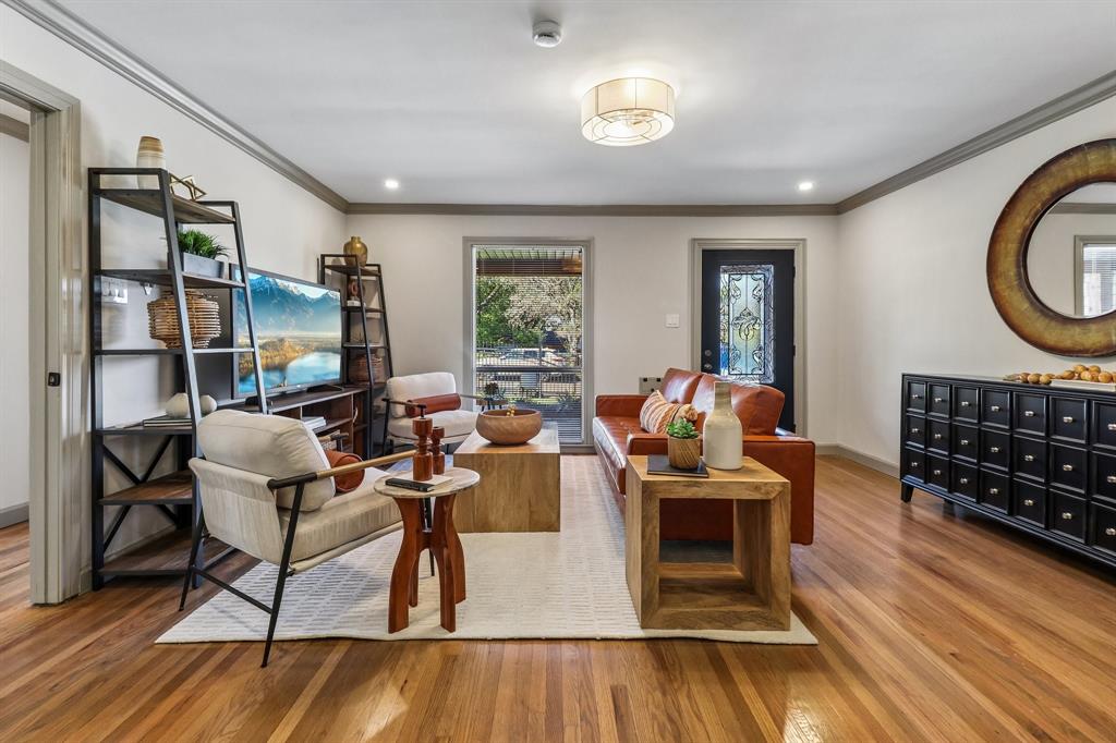 Hardwood flooring, recessed lighting, crown molding, modern light fixture, and a decorative entry door Hardwood flooring, recessed lighting, crown molding, modern light fixture, and a decorative entry door