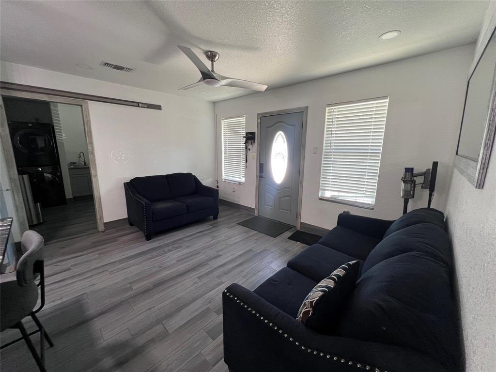 Wood-finish flooring, recessed lighting, ceiling fan, sliding barn door, and exterior entry door with glass insert Wood-finish flooring, recessed lighting, ceiling fan, sliding barn door, and exterior entry door with glass insert
