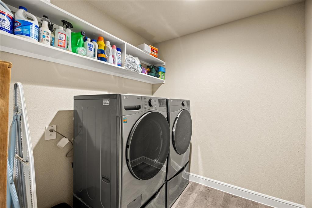 Good sized laundry room with shelving.
