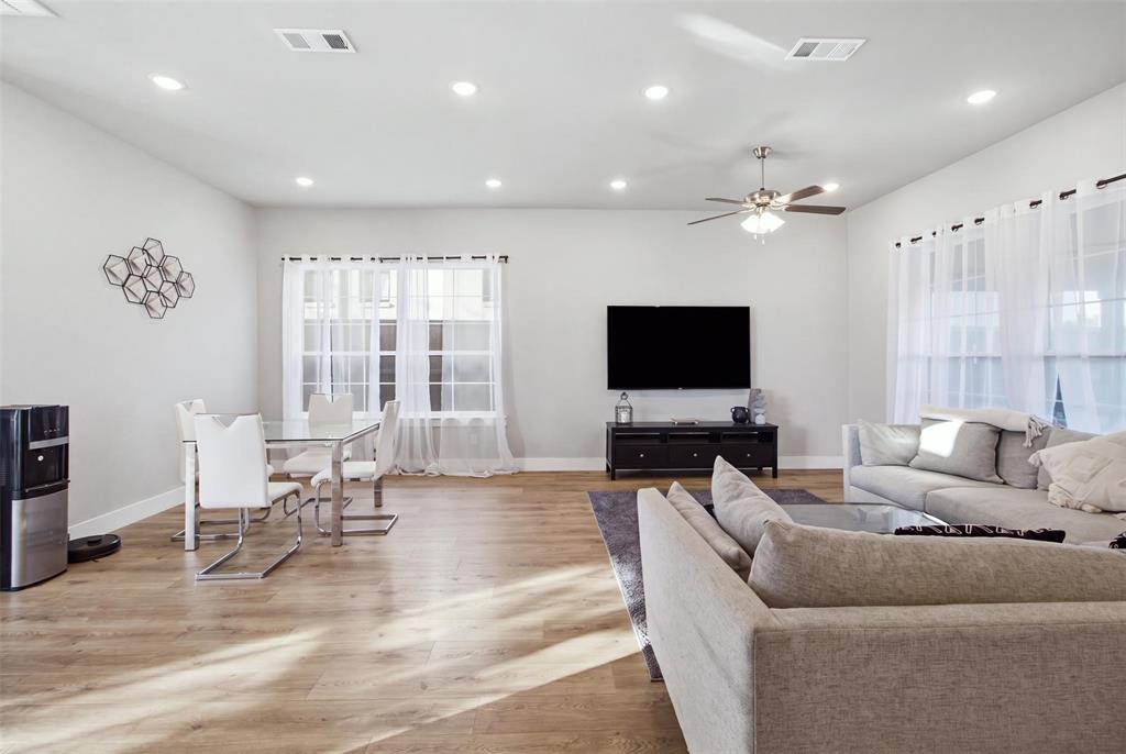 Open-concept living space featuring wood-finish flooring, recessed lighting, and a ceiling fan