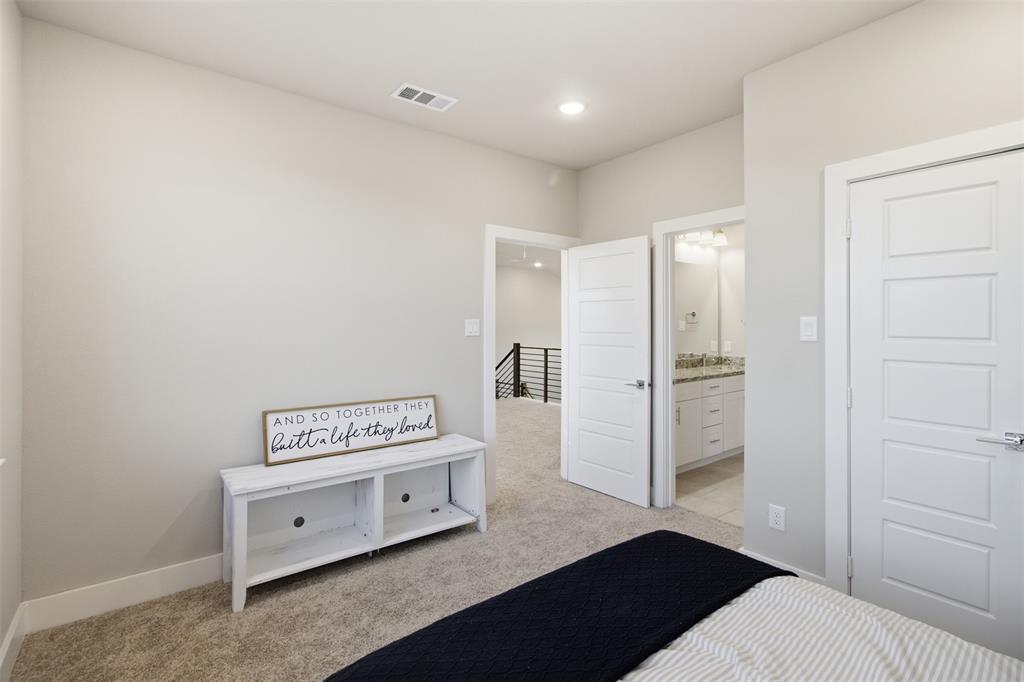 Neutral-toned interior featuring wall-to-wall carpeting, five-panel doors, recessed lighting, and built-in vanity cabinetry