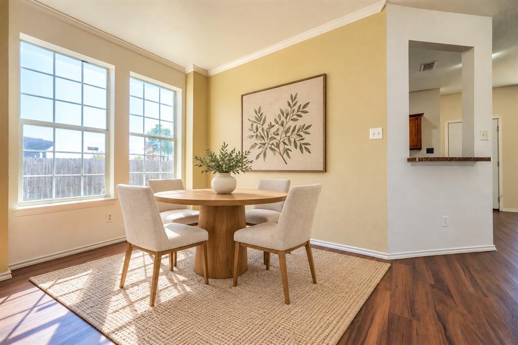 Wood-finish flooring, dual grid-pane windows, and a pass-through opening with a ledge