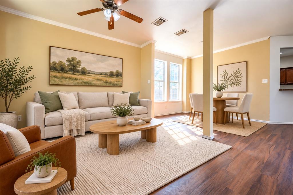 Living space featuring wood-finish flooring, neutral wall paint, and a ceiling-mounted fan with integrated lighting
