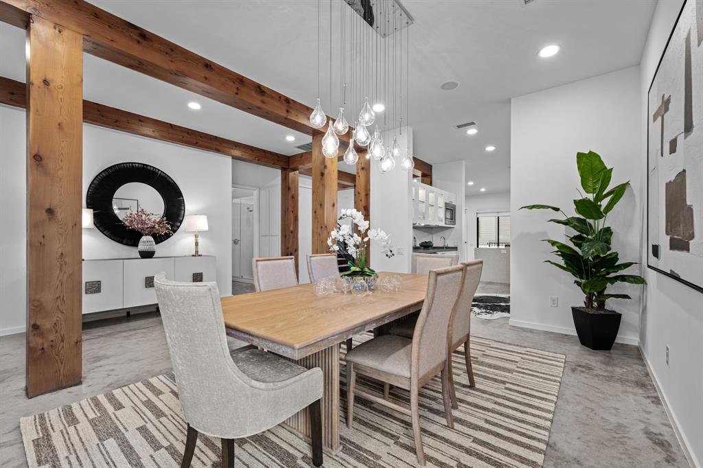 Gather beautifully in a dining room framed by warm wood and sculptural lighting.