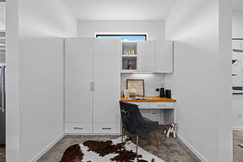 A built-in desk and generous storage create an organized hub for your kitchen pantry with a doggy door hidden underneath leading to the gated dog run.