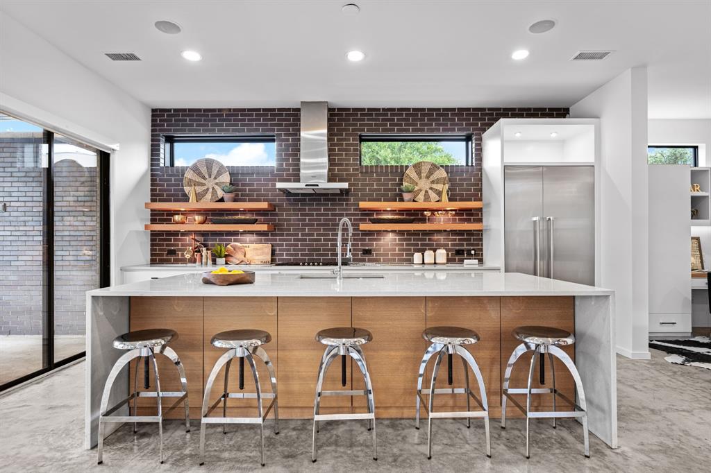 The kitchen’s generous island brings cooking, conversation, and gathering together.