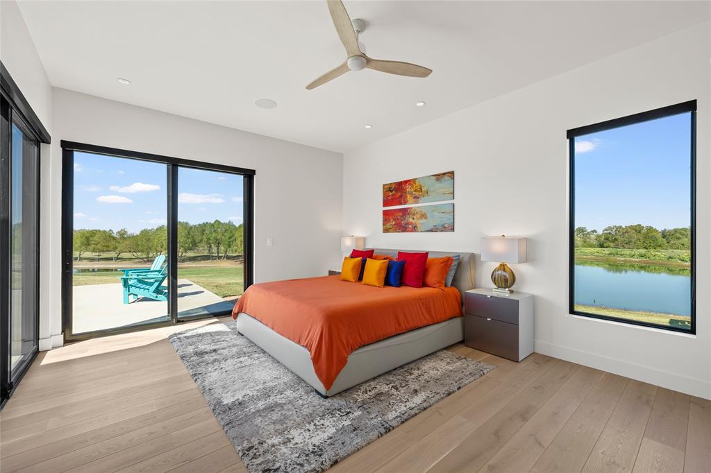 Wood flooring, expansive sliding glass patio doors, recessed lighting, ceiling fan, and large windows with panoramic views