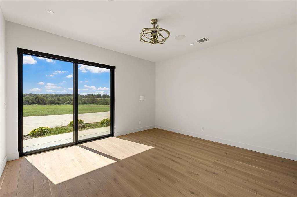 Guest room/studio/office featuring wood flooring, sliding glass doors with own private entrance, custom ceiling fan surround sound, and recessed lighting