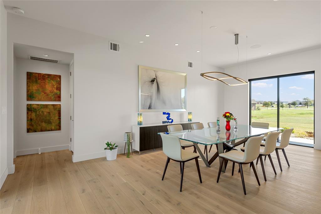 Wood flooring, recessed lighting, modern geometric fixture, and large-format sliding glass doors