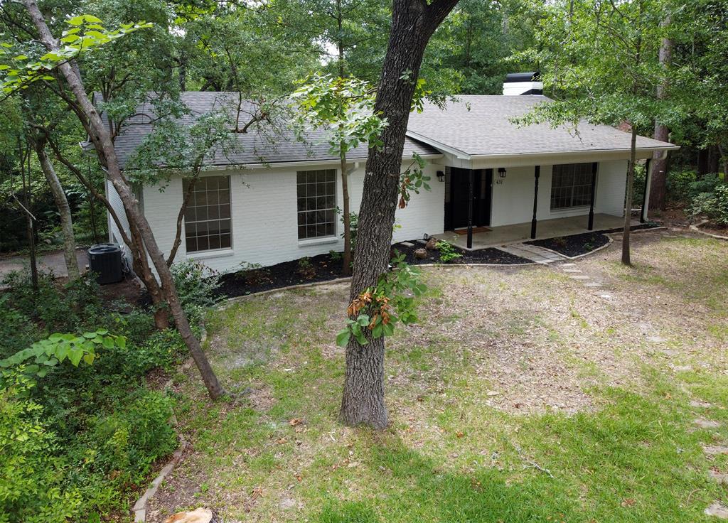 Single-story exterior featuring a white painted brick facade, covered front porch, asphalt shingle roof, chimney, and multi-pane windows Single-story exterior featuring a white painted brick facade, covered front porch, asphalt shingle roof, chimney, and multi-pane windows