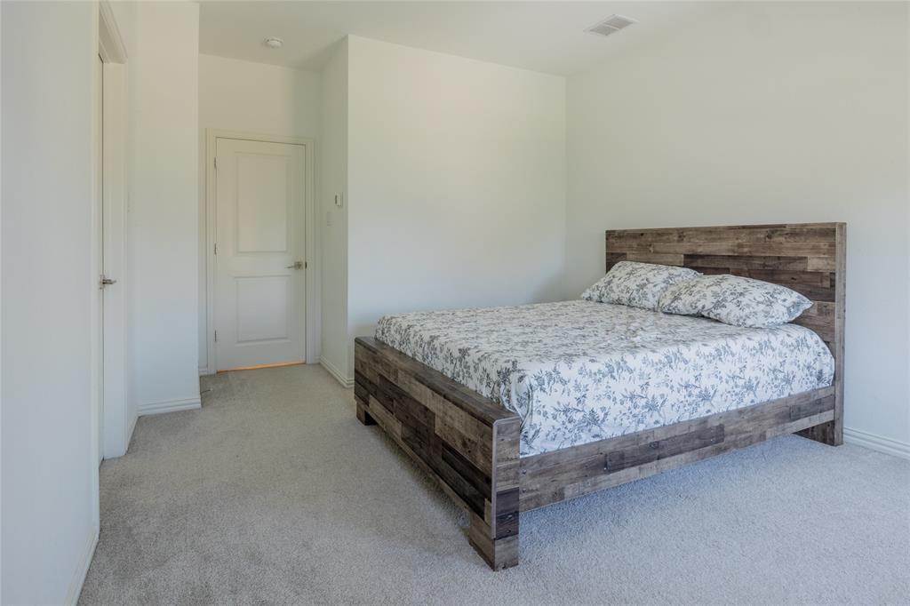 Neutral-toned carpeting, crisp white walls, and a multi-panel interior door