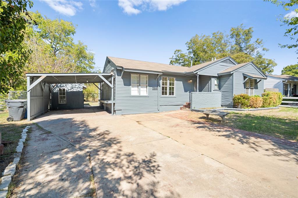 Single-story residence featuring horizontal lap siding, a covered carport, and a concrete driveway