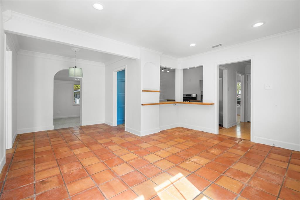 Interior space featuring terracotta tile flooring, recessed lighting, archway, and wood-topped counter