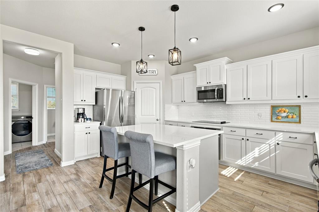 Bright, open kitchen with quartz and stainless steel appliances Bright, open kitchen with quartz and stainless steel appliances