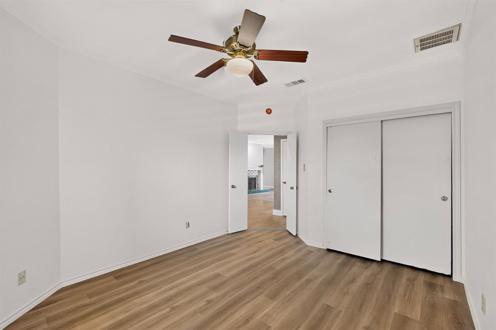 Fresh paint and newly installed flooring in the second bedroom.