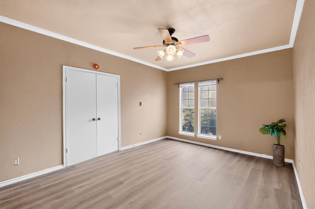 Double doors between the primary bedroom and living area create a stately suite.