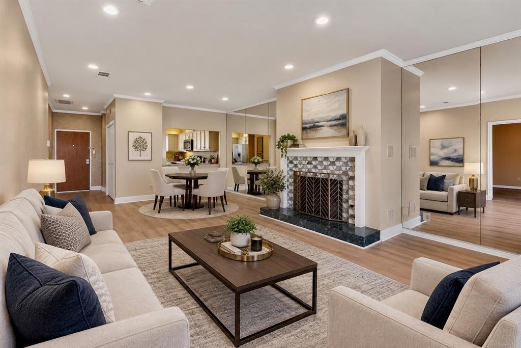 Virtually staged – Envision the life you want in this warm, inviting open-concept condo with recessed lighting, laminate flooring through out, and beautiful modern tiled fireplace.