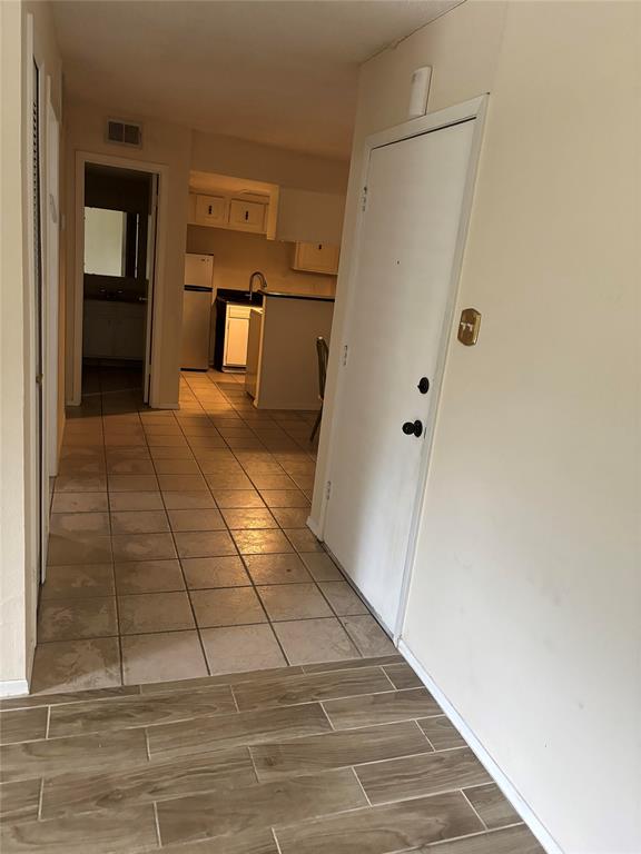 Hall with light tile floors