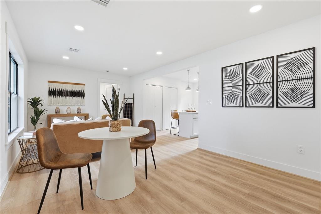 Neutral-toned interior featuring wood-finish flooring, recessed lighting, and crisp white walls Neutral-toned interior featuring wood-finish flooring, recessed lighting, and crisp white walls